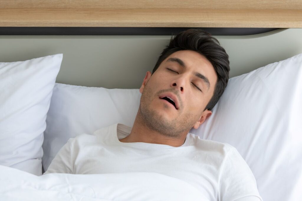 man-was-sleep-and-snore-in-the-white-bedroom-of-th-2025-01-08-02-26-07-utc - Pure Health Dental Man suffering from Sleep-Related Breathing Disorders